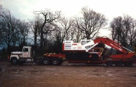 Semi truck loaded with a large excavator