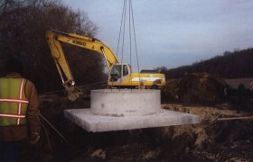 Lowering a large concrete culvert into a pit