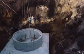 Lowering a large concrete culvert into a pit