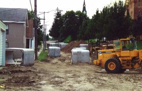 Concrete culverts sitting at a road construction site in a town